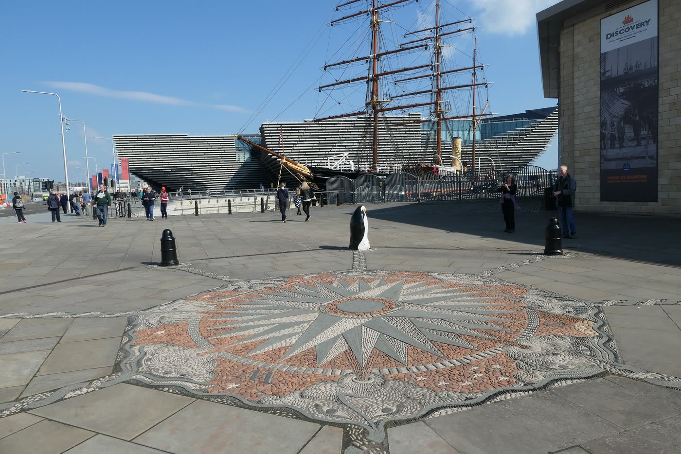 The compass-rose mosaic set into the paving at Discovery Point, with RRS Discovery and V&A Dundee behind it.